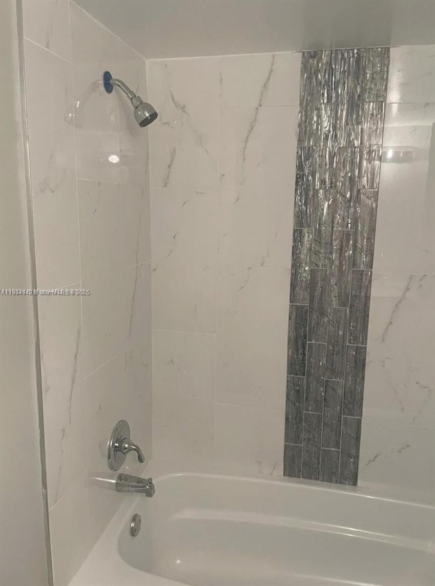 3252 Foxcroft Road, Unit 314 Miramar, FL 33025 - Photo 8 of 9 a bathroom with a bathtub