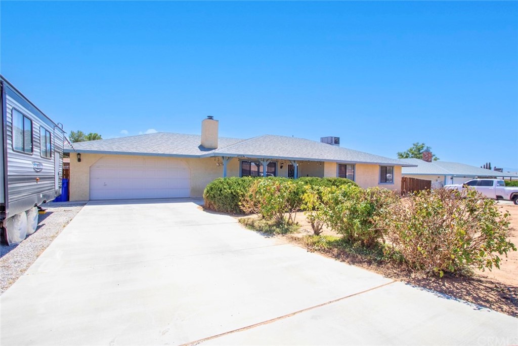 22703 Motnocab Road Apple Valley, CA 92307 - Photo 1 of 1 a front view of a house with a yard