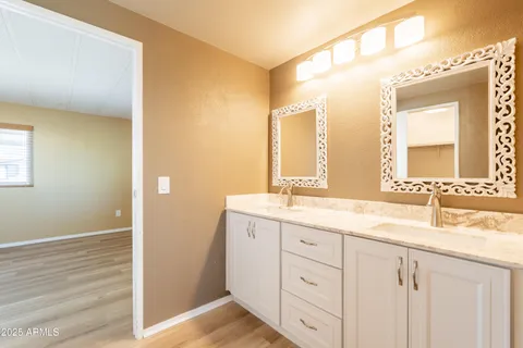 a bathroom with a double vanity sink and a mirror