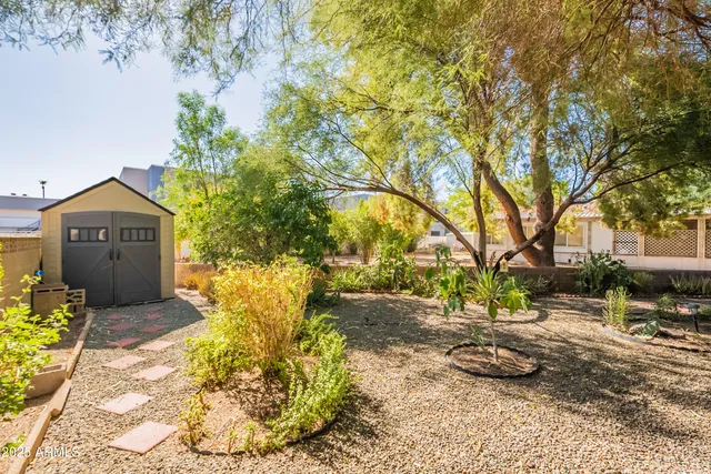 a backyard of a house with table and chairs