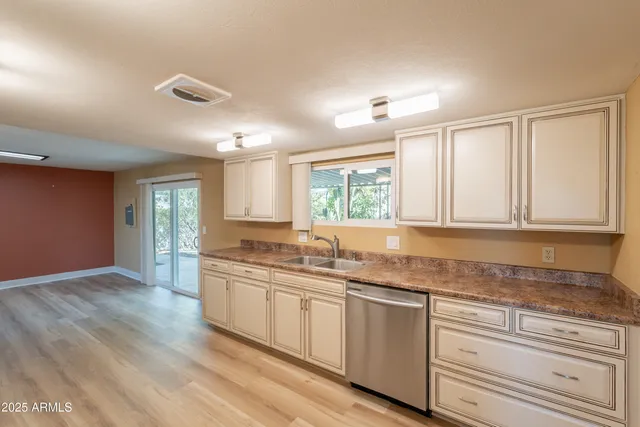 a kitchen with granite countertop cabinets and window