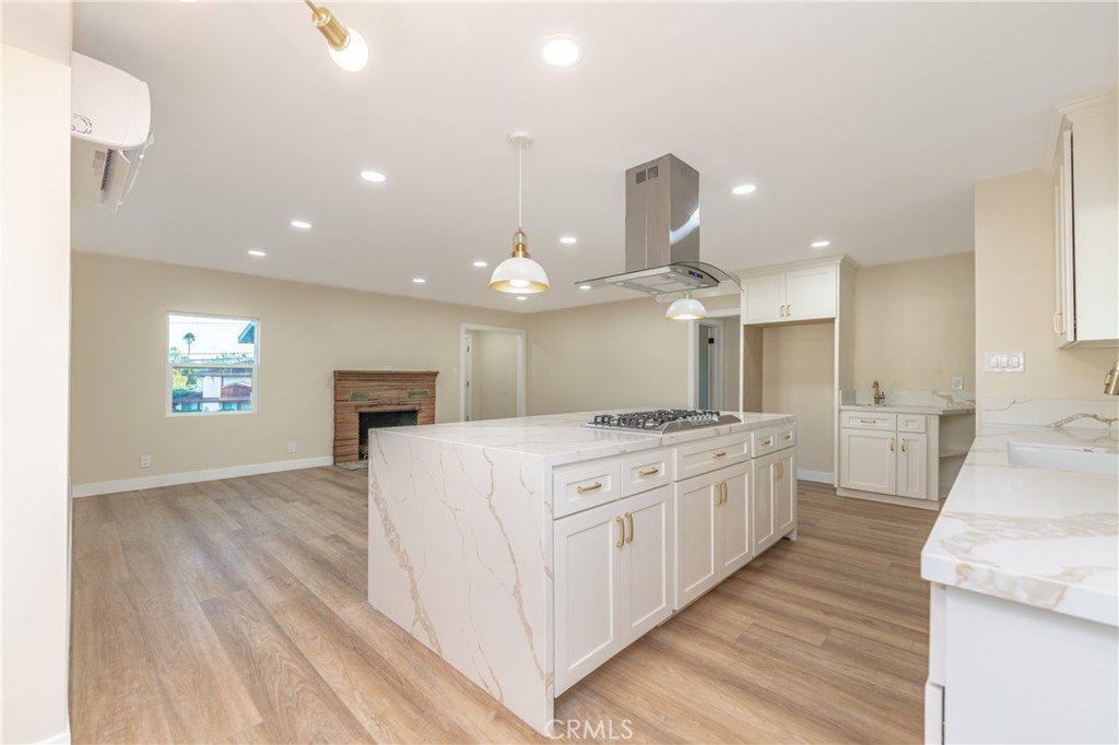 14331 Leffingwell Road Whittier, CA 90604 - Photo 1 of 1 a large kitchen with kitchen island a stove a sink a refrigerator and a fireplace