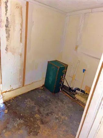 a room with a wooden floor and white wall