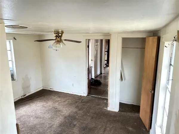 a bedroom with a bed and a chair