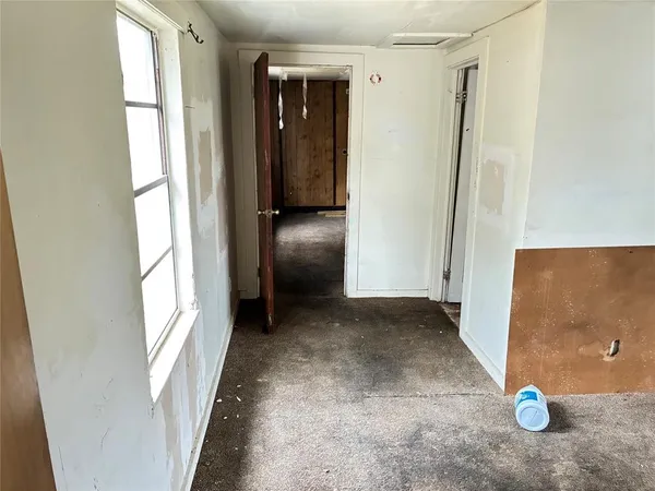 an empty room with windows and closet