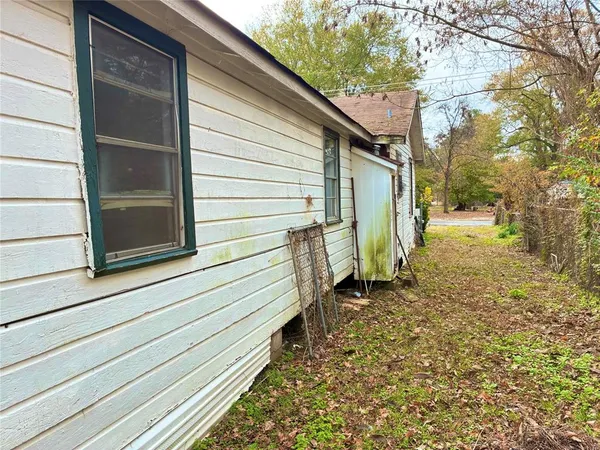 a view of a house with a yard and wooden fence