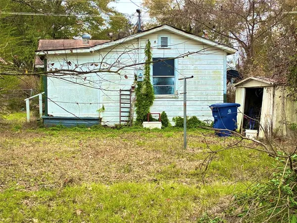 a view of a two chairs in the backyard