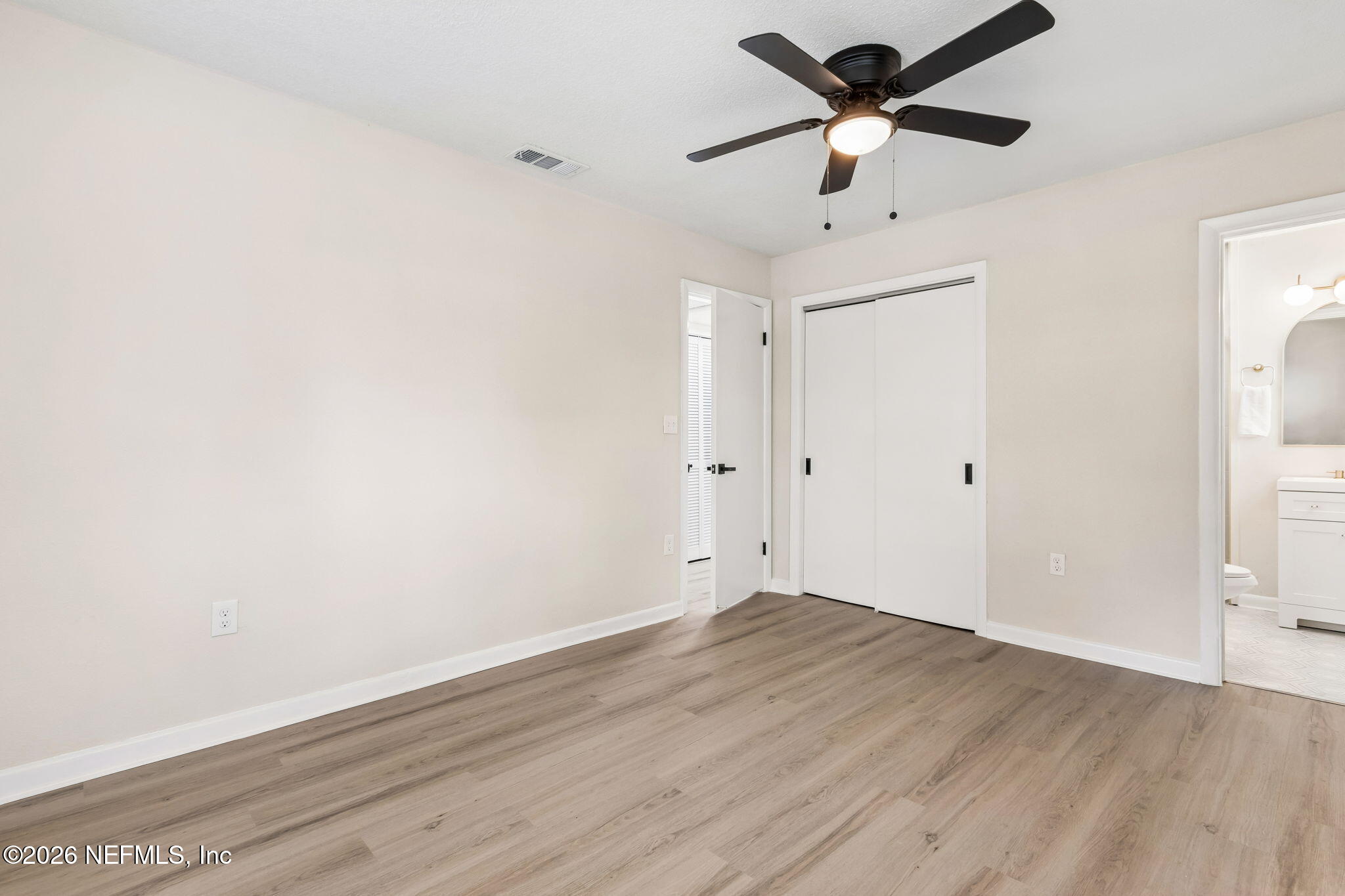 3668 Marianna Road Jacksonville, FL 32217 - Photo 17 of 28 a view of a big room with wooden floor and a ceiling fan