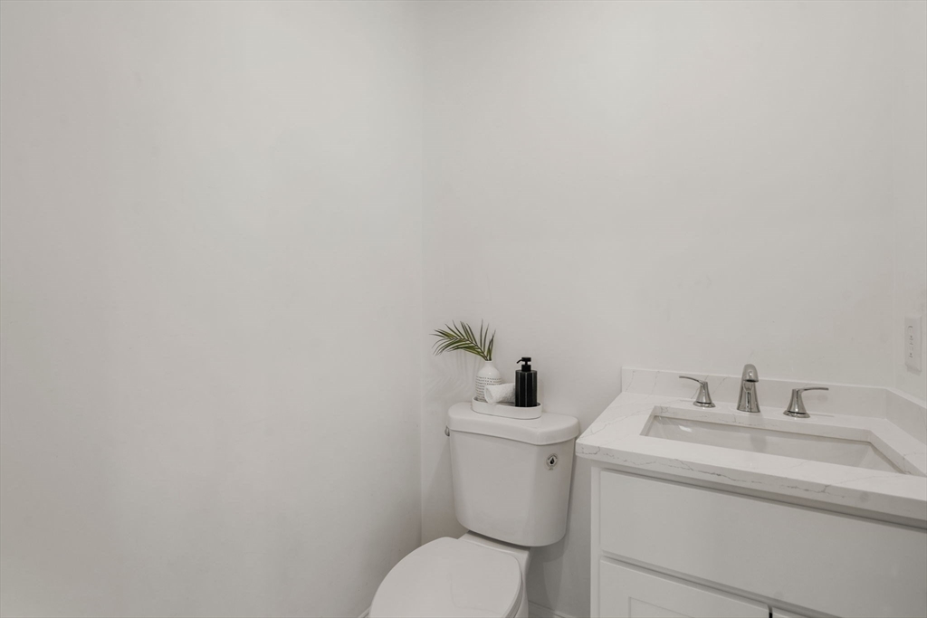 28 Waltham Street, Unit B Maynard, MA 01754 - Photo 16 of 17 a bathroom with a toilet sink and mirror