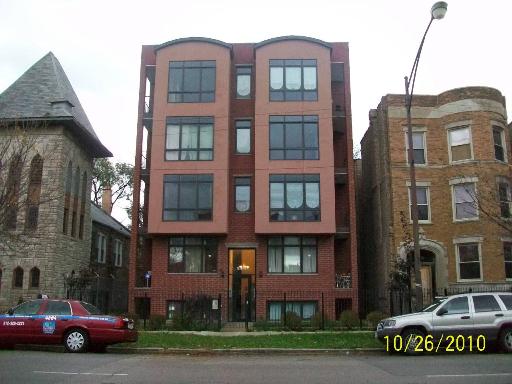 4419 South Indiana Avenue, Unit 4 Chicago, IL 60653 - Photo 1 of 1 a car parked in front of a brick building
