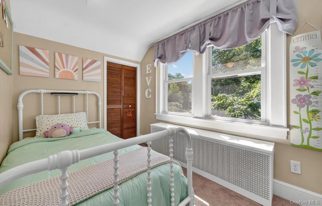 34 Ridge Road Croton-on-Hudson, NY 10520 - Photo 27 of 35 Second upstairs bedroom featuring a closet, wall of windows and vaulted ceiling