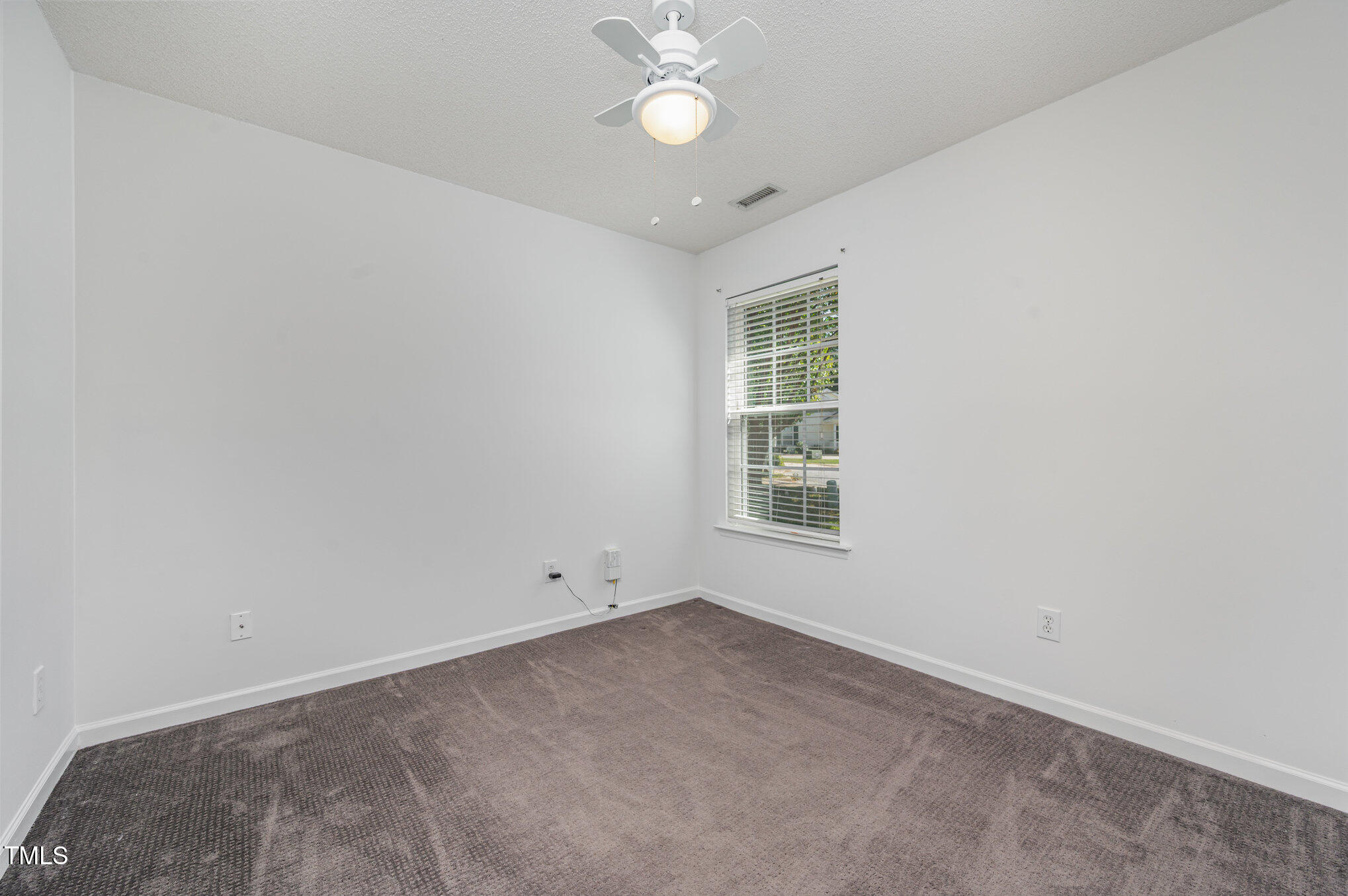 102 Checker Court Apex, NC 27502 - Photo 10 of 15 an empty room with a fan & a window