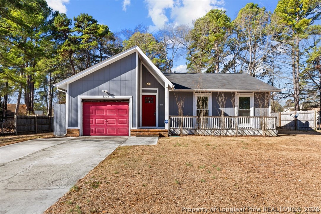 3305 Hunting Bay Drive Spring Lake, NC 28390 - Photo 2 of 27 a front view of a house with a yard and garage