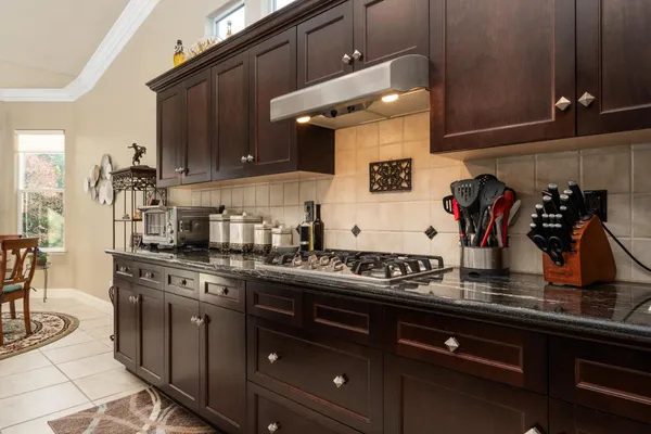 a kitchen with a sink a stove and cabinets