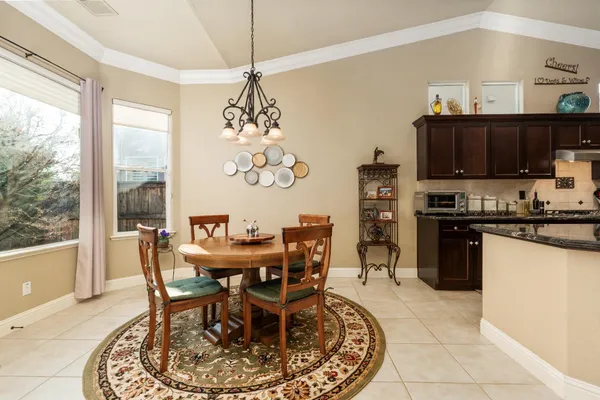a view of a dining room with furniture wooden floor and chandelier
