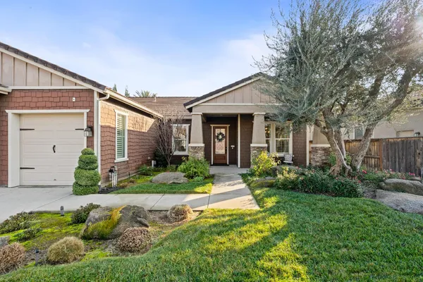 a front view of a house with garden and porch