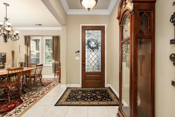 a view of a hallway and dining room with furniture