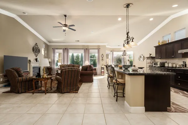 a living room with lots of furniture and kitchen view