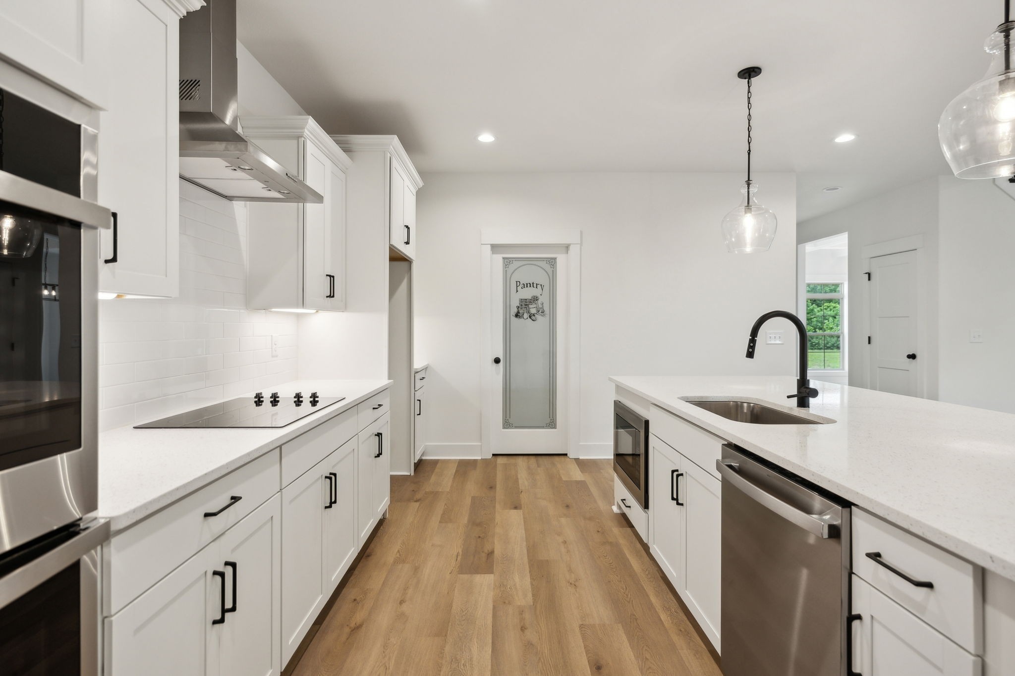 1075 Linder Ridge Road Indian Mound, TN 37079 - Photo 11 of 29 a kitchen with white cabinets a sink dishwasher and a stove with wooden floor