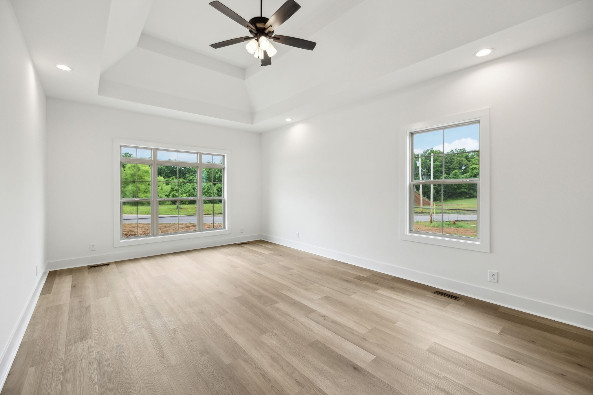 1075 Linder Ridge Road Indian Mound, TN 37079 - Photo 13 of 29 an empty room with wooden floor chandelier fan and windows