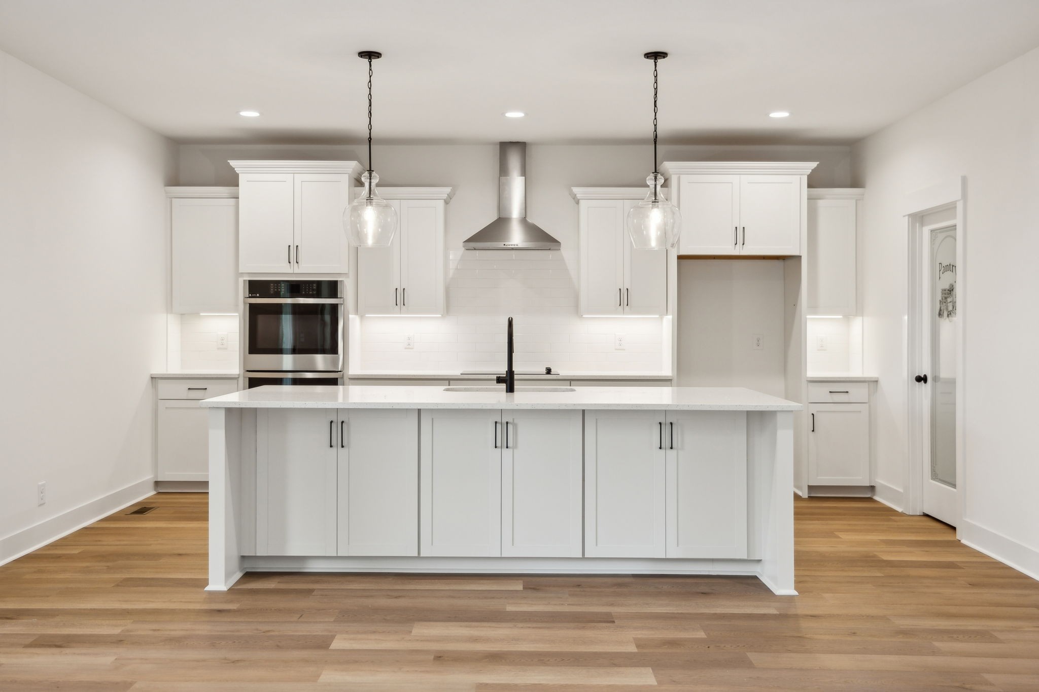 1075 Linder Ridge Road Indian Mound, TN 37079 - Photo 9 of 29 a kitchen with stainless steel appliances a kitchen island hardwood floor sink and stove