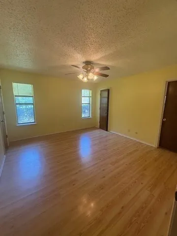 a view of a room with window and wooden floor