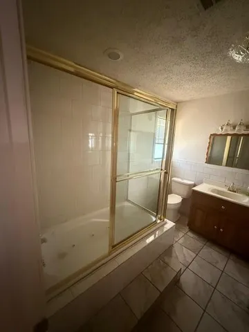 a bathroom with a shower and mirror