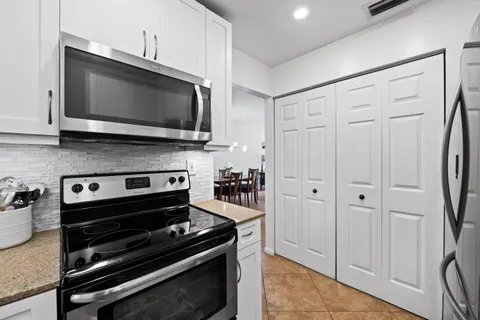 a kitchen with a stove and a microwave