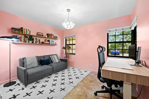 a living room with furniture a desk and chair with wooden floor