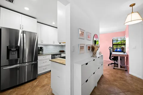 a kitchen with stainless steel appliances a refrigerator sink and cabinets