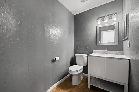 a bathroom with a toilet sink and mirror