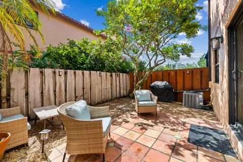 a view of a chairs and tables in the back yard of the house