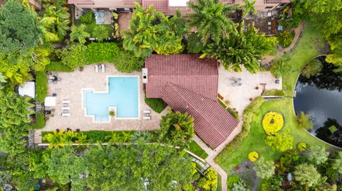 an aerial view of a house with a swimming pool