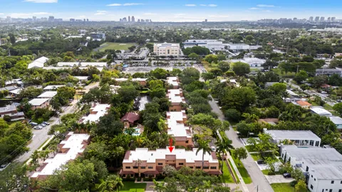 an aerial view of residential houses with city view