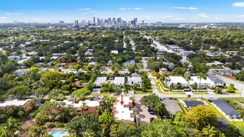an aerial view of residential houses with outdoor space and trees