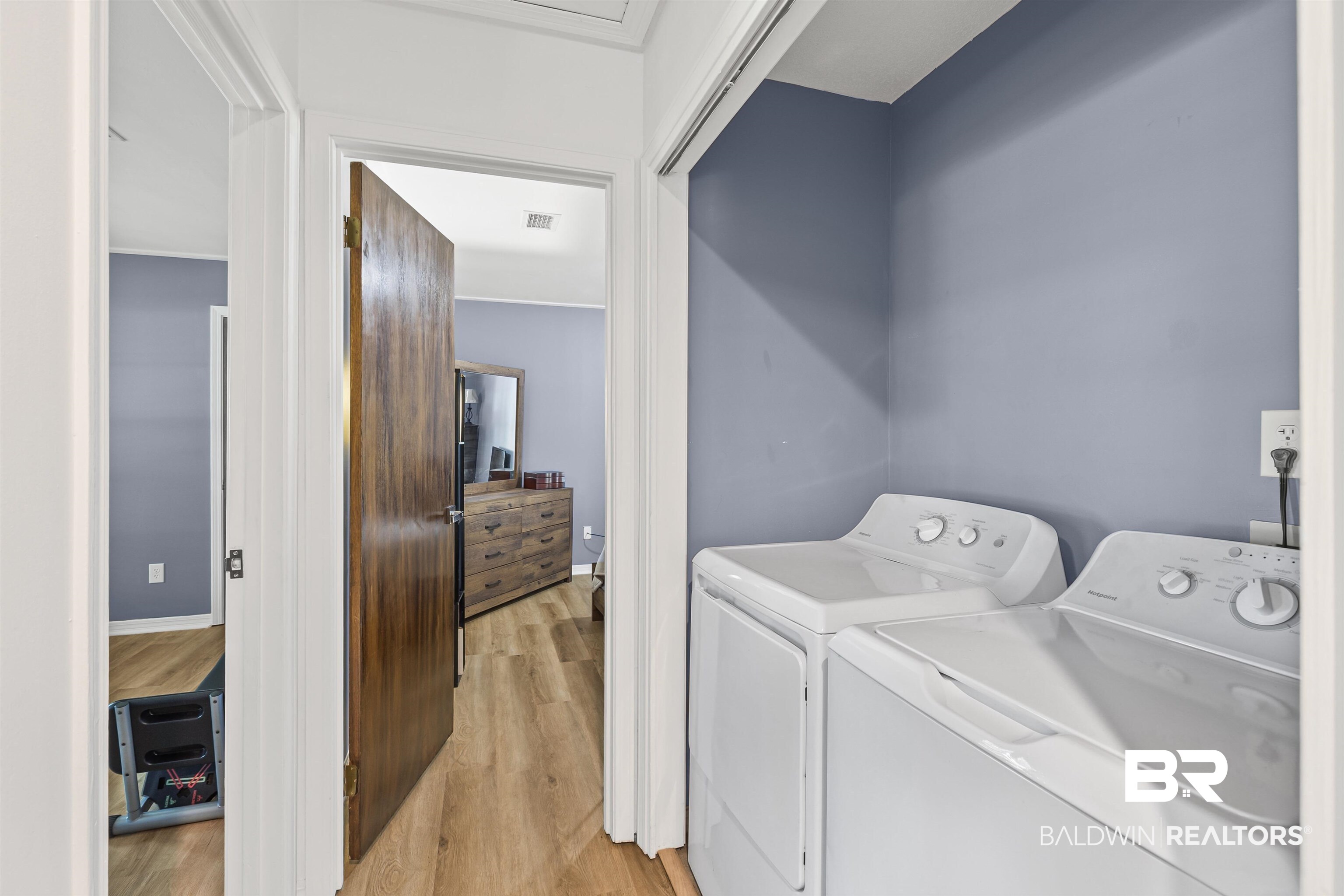 8911 Owassa Road Evergreen, AL 36401 - Photo 19 of 24 Laundry room with light wood-style flooring and washing machine and dryer