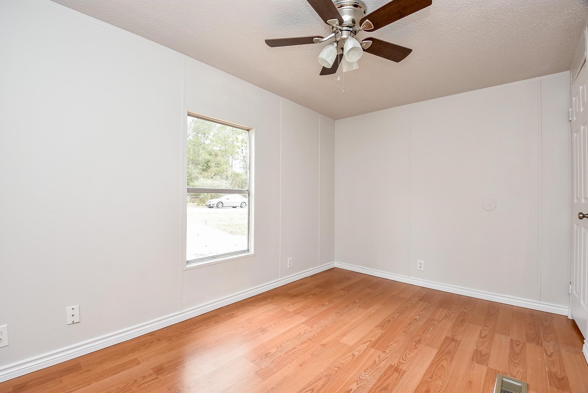 12842 Roy Harris Loop Conroe, TX 77306 - Photo 35 of 36 an empty room with a window