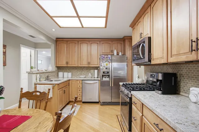 a kitchen with a stove a sink and a refrigerator