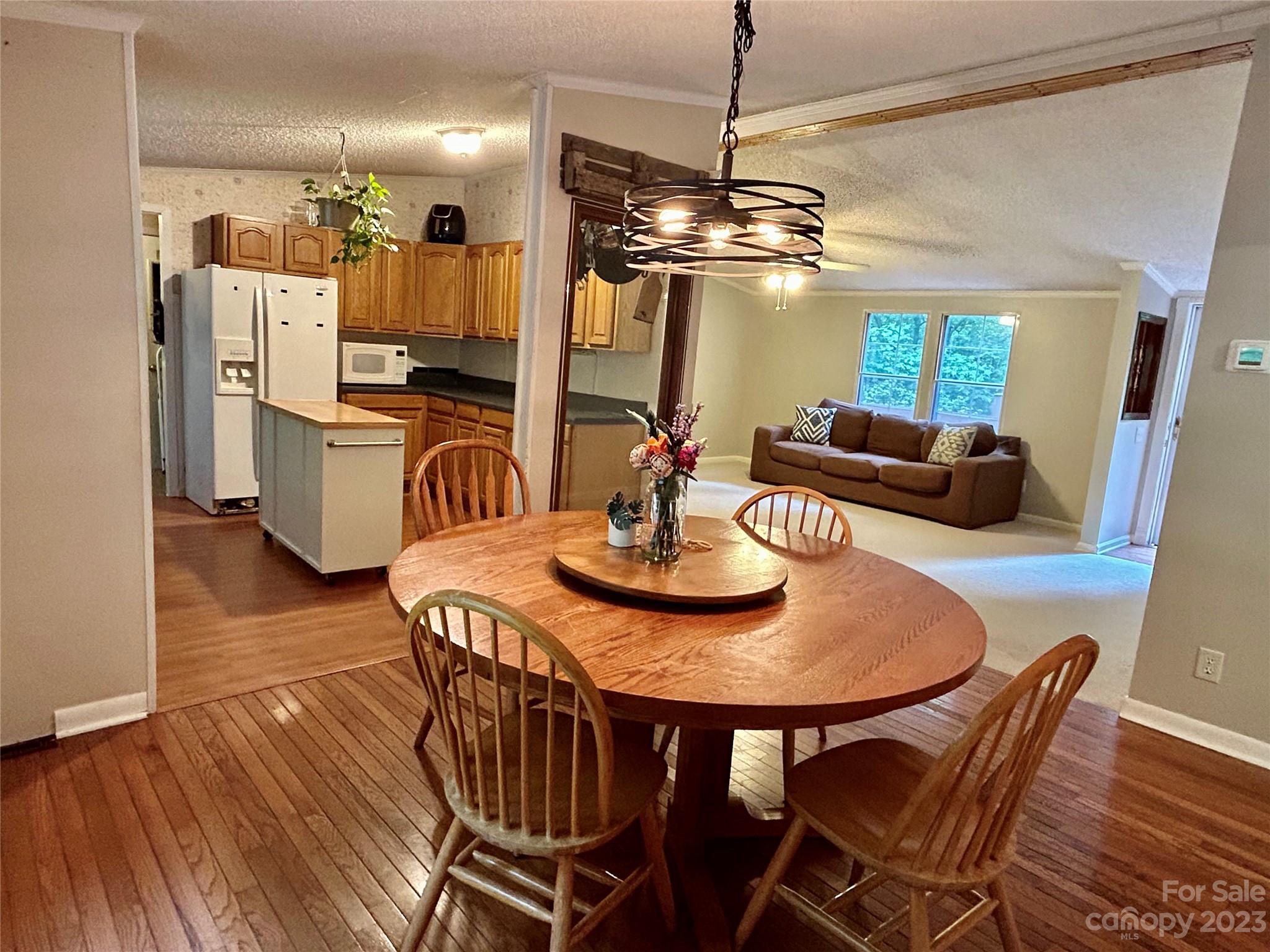 71 Bear Trail Fairview, NC 28730 - Photo 17 of 42 a view of a dining room with furniture a chandelier and wooden floor