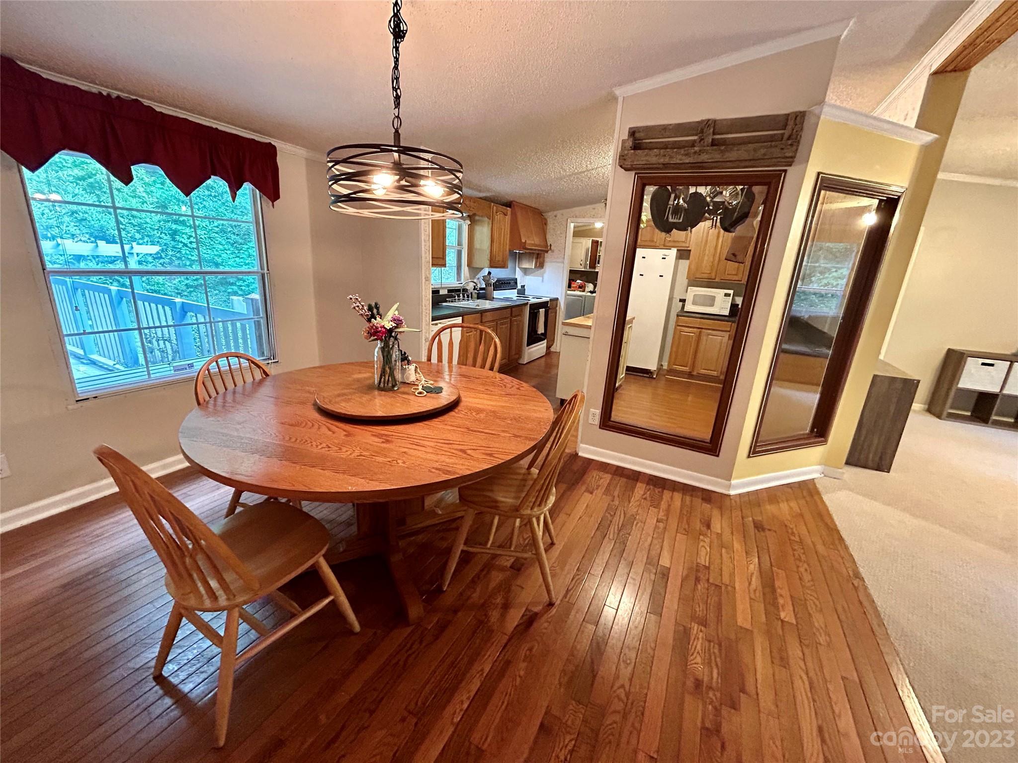 71 Bear Trail Fairview, NC 28730 - Photo 18 of 42 a dining room with furniture window and wooden floor