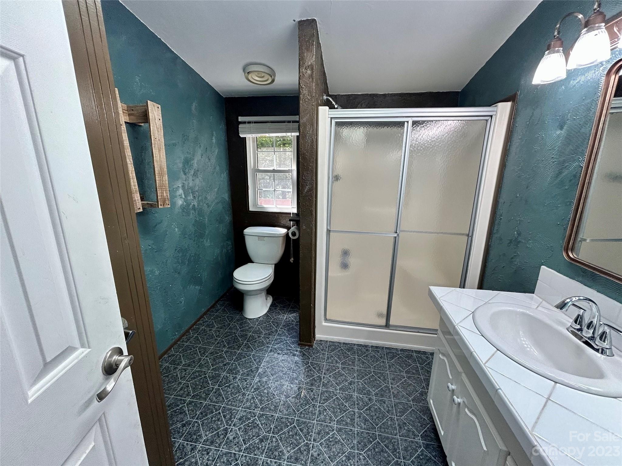 71 Bear Trail Fairview, NC 28730 - Photo 26 of 42 a bathroom with a granite countertop sink toilet and shower