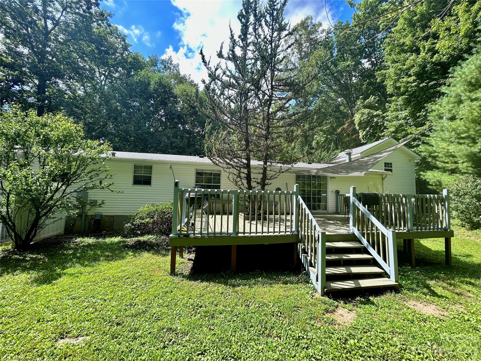 71 Bear Trail Fairview, NC 28730 - Photo 6 of 42 a view of a chair and table in backyard of the house