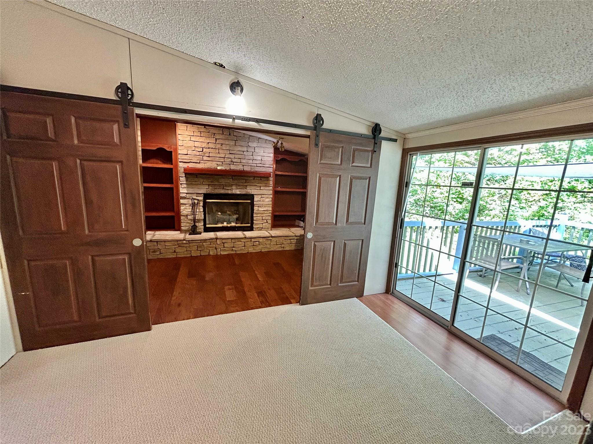 71 Bear Trail Fairview, NC 28730 - Photo 8 of 42 a view of a kitchen with furniture fridge and wooden floor