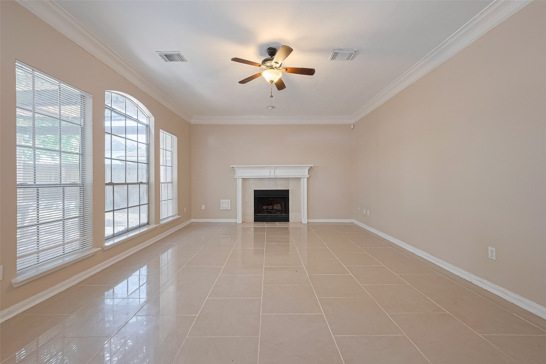 24310 Pepperrell Pl Street Katy, TX 77493 - Photo 12 of 35 a view of an empty room with a fireplace and a window