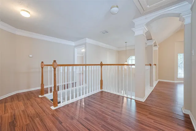 a view of a hallway with wooden floor