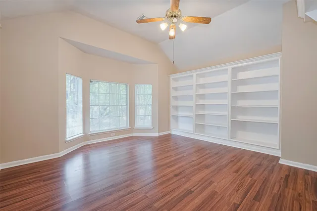 a view of wooden floor and windows in a room