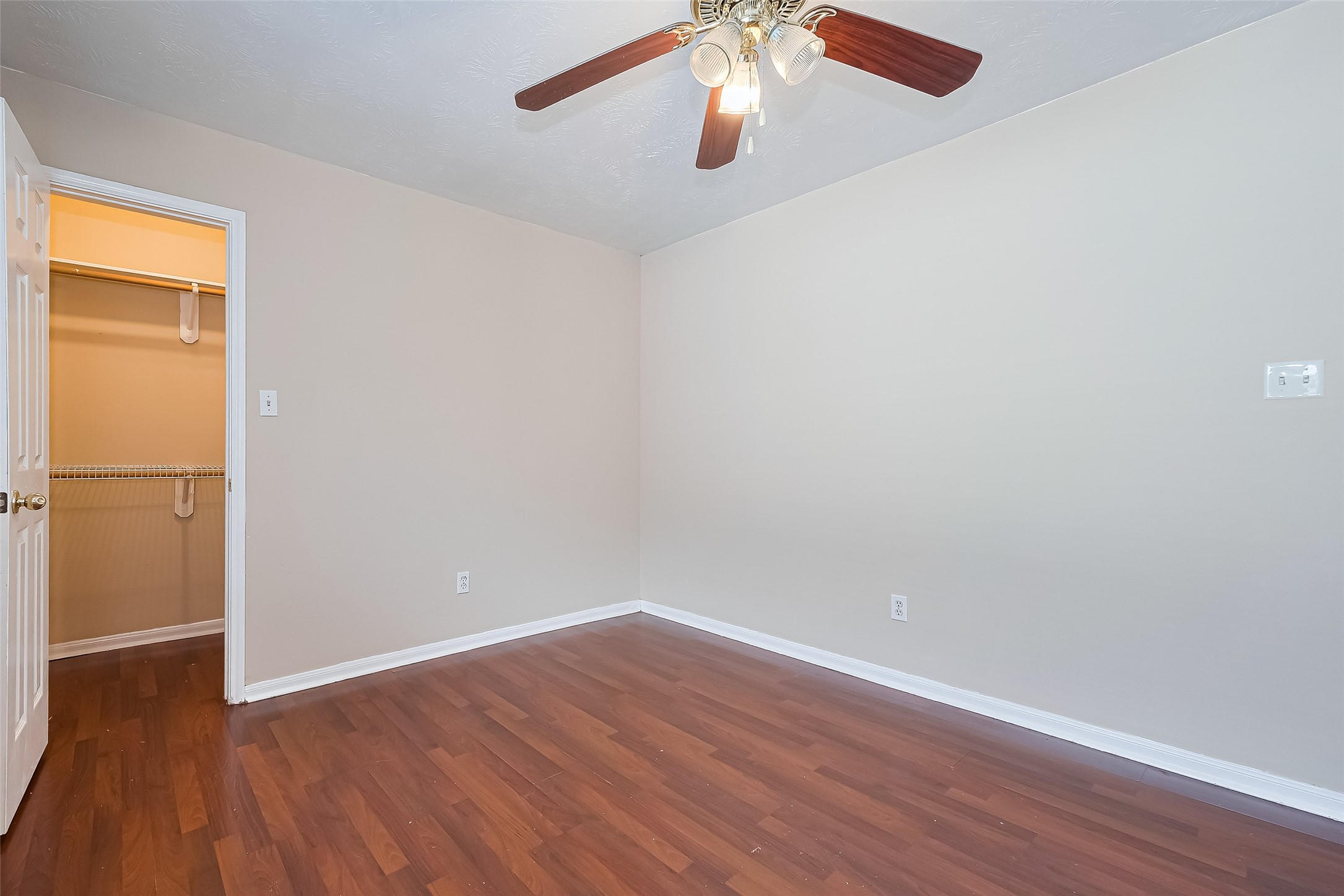 24310 Pepperrell Pl Street Katy, TX 77493 - Photo 23 of 35 an empty room with wooden floor and chandelier fan