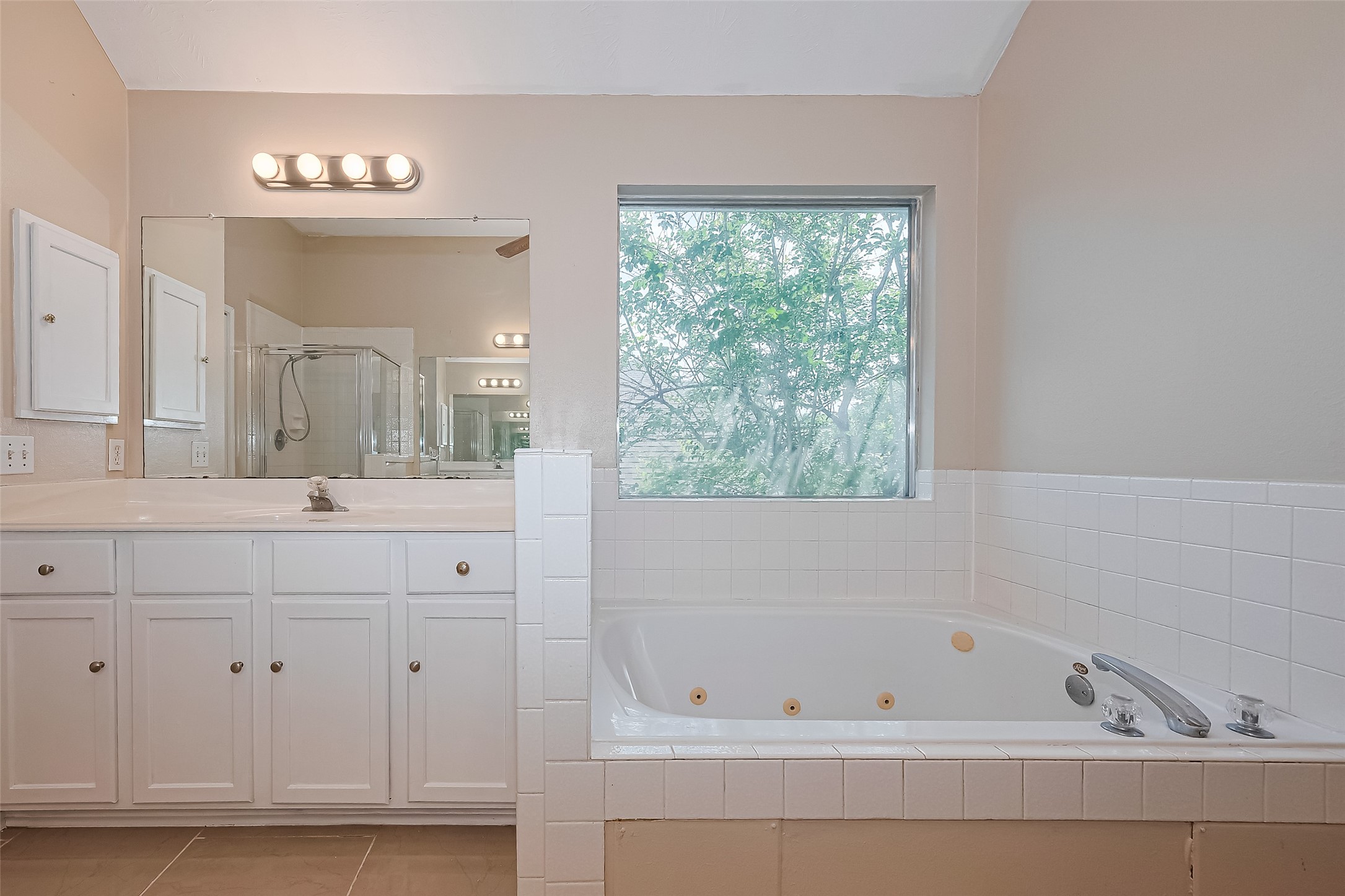 24310 Pepperrell Pl Street Katy, TX 77493 - Photo 28 of 35 a bathroom with a bathtub a sink and a window