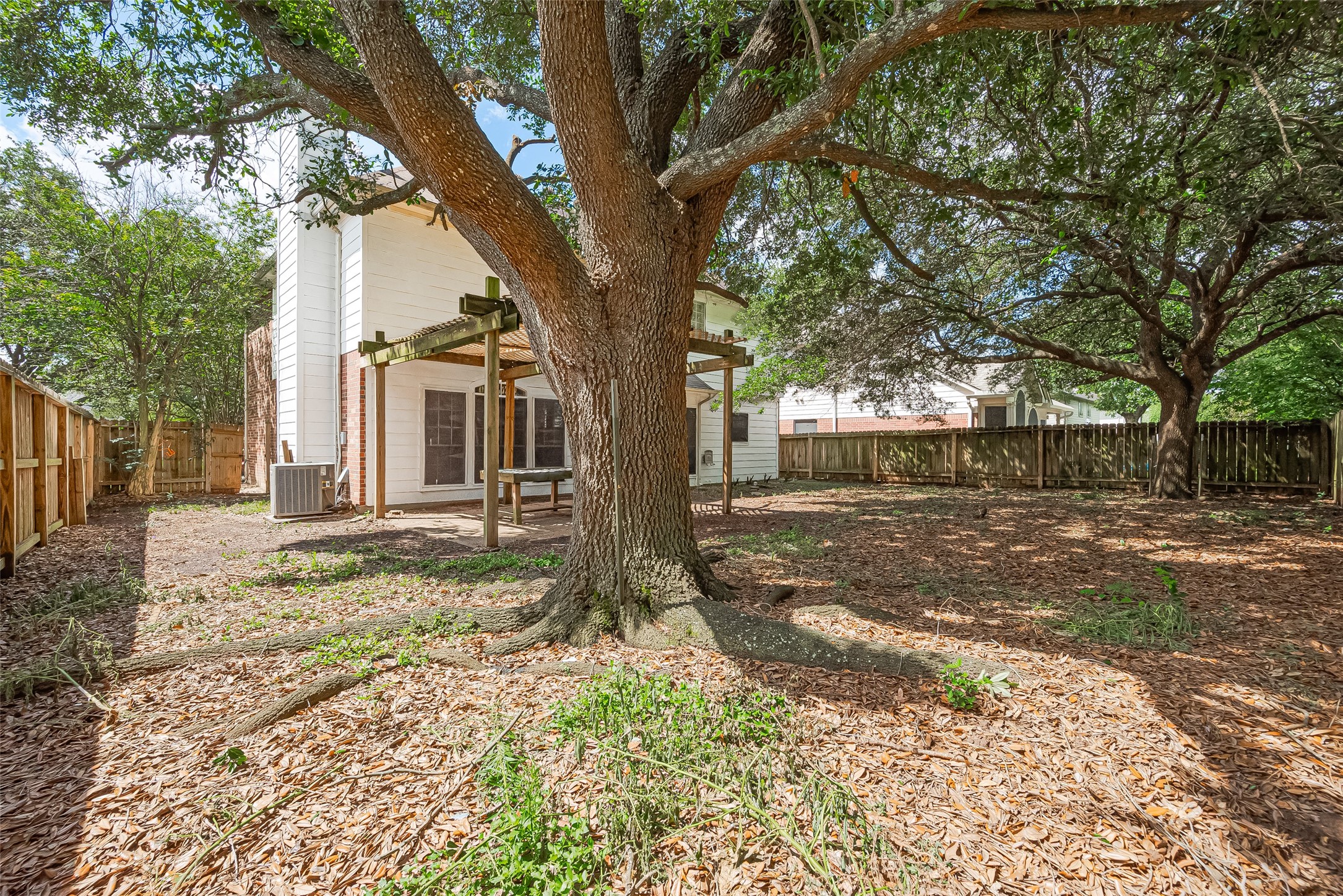 24310 Pepperrell Pl Street Katy, TX 77493 - Photo 34 of 35 a view of a yard with a tree in the background