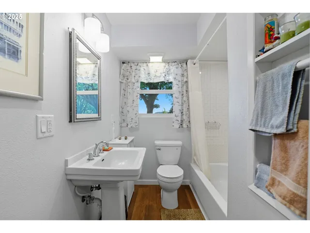 a view of kitchen with stainless steel appliances cabinets and wooden floor